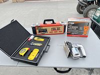 Overall view of jigsaw, router box and open measuring tool set on table