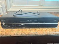 Front view of Toshiba SD-V296 unit with cable on top