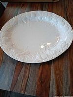 overall view of white oval platter showing embossed grape motif