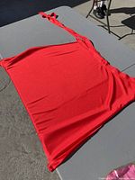 Red knit camisole laid flat on table