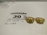 Both 10K gold peridot rings side by side on white background