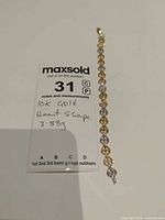 Full view of bracelet beside lot card showing weight and 10K gold note