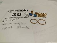 All items grouped: opal studs, knot studs, two rings