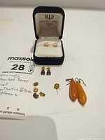 Group shot showing all earring pairs and The Opal Centre box