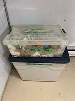 Two stacked plastic totes holding contents of lot