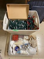 Overall view: tote with string lights and separate clear tote of candles