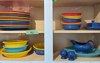 Stacked dinner and salad plates, oval dishes, gravy boat, butter dish, shakers