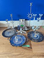 Group shot of trays, candlesticks, cheese knives, clock and figurines