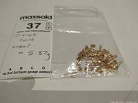 Bag containing mixed yellow gold earring findings with weight note