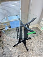 Full view of round glass table with metal base