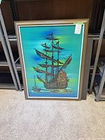 Full view of framed artwork showing ship image and frame