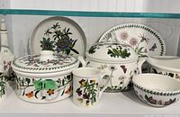Group shot shows majority of pieces: covered casserole, tureen, plates, mug, bowls