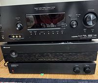 Front view of stacked Sony receiver, Russound controller and AudioSource amplifier