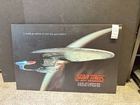 Front view of mounted poster showing full artwork and logo