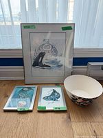Group shot of three framed prints and bowl