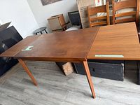 Table closed with one leaf pulled partway, shows overall form and wear