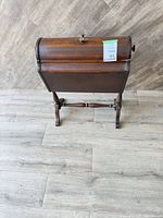 Front angled view of closed roll-top cabinet on pedestal base