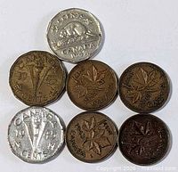 Group shot of seven coins showing obverse dates and designs