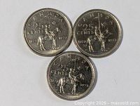Three 1973 Canada 25-cent coins reverse side