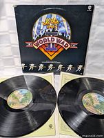 Both vinyl records with centre labels and inner sleeves