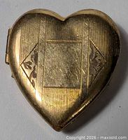 Front view of gold plated heart locket showing engraved pattern