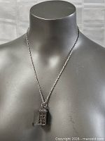Necklace displayed on bust showing pendant and chain length