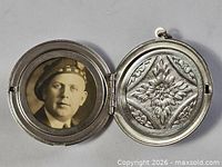 Locket fully open showing portrait photo and floral panel