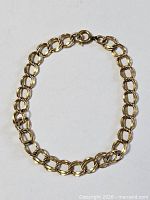 Full view of gold-plated bracelet arranged in loop