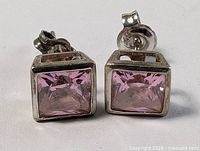 front view of both square pink stone earrings