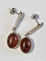 Full view of both sterling silver amber drop earrings