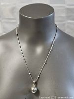 Full view of chain on bust displaying pendant