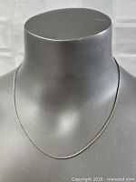 Chain on bust displaying full length and drape