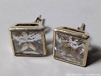 front view of both square crystal earrings showing bezel setting