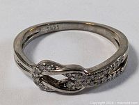 Top view of sterling silver infinity ring showing S925 hallmark inside band