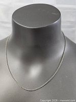 Full view of sterling silver chain on display bust