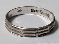 Full view of sterling silver band showing exterior ridge and dot pattern