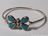 Full view of sterling bangle showing butterfly front and hinge clasp
