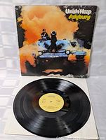 Front jacket artwork with vinyl displayed