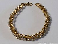 Full view of gold-plated bracelet in circular form