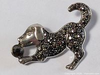 Front view of silver-tone dog brooch with faceted stones