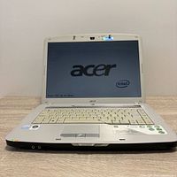 Laptop open showing screen with Acer logo and Intel, keyboard visible
