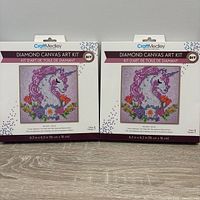 Front view of two sealed CraftMedley unicorn diamond canvas art kits