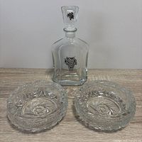 Decanter with stopper and two bowls front view