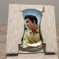 Front view of Elvis Presley porcelain plate in protective cardboard insert