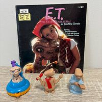 Front cover of 24-page E.T. read-along book and three plastic figures