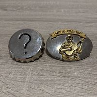 Front view of both belt buckles showing designs
