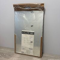 Front view of sealed IKEA Budd mirror set package showing mirror surface and mounting guide