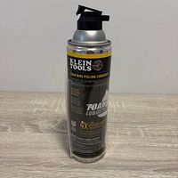 Front view of Klein Tools foam wire pulling lubricant can with straw attached