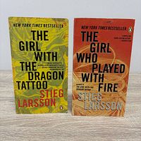 Front covers of both paperbacks standing upright