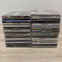 Two stacks of CDs showing several identifiable titles